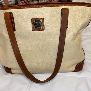 Dooney & Bourke  cream colored, pebble leather lots of pockets and storage